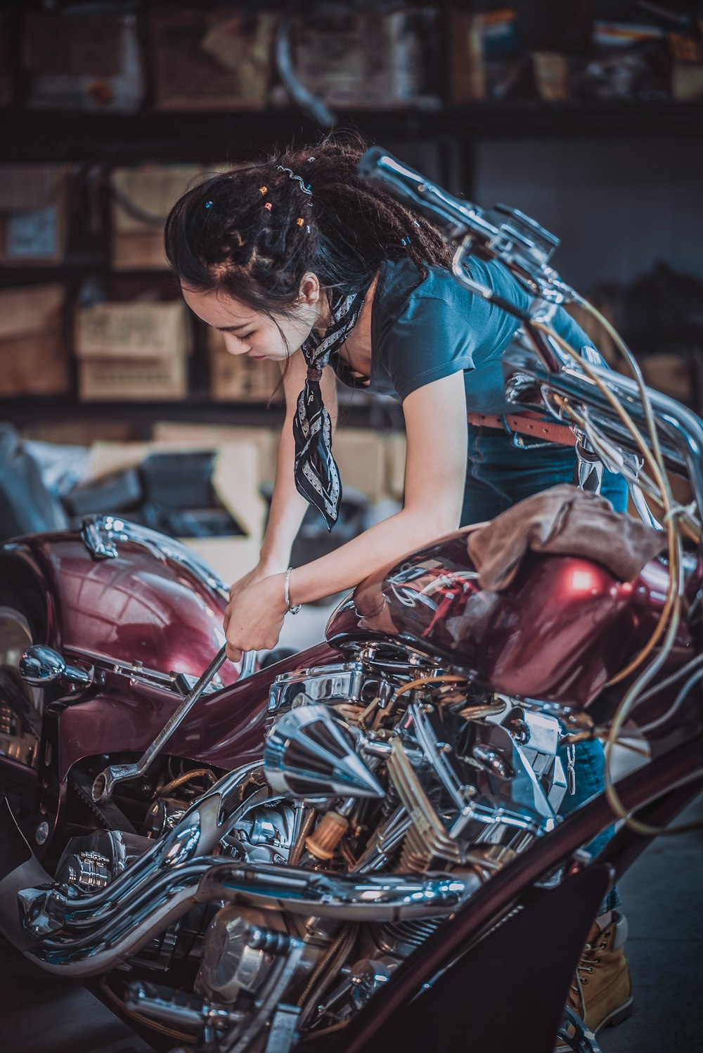 photo of woman repairing motorcycle
