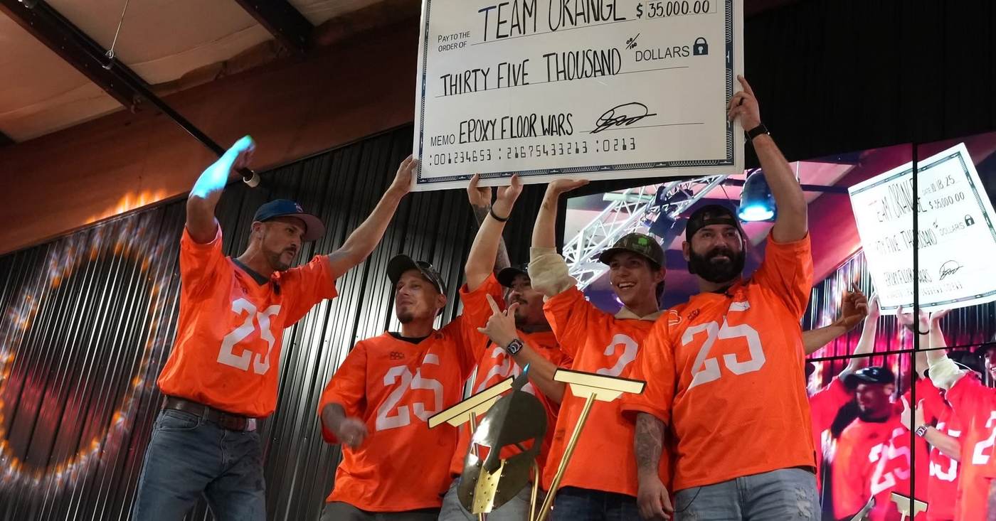 Team Orange celebrating with the Epoxy Floor Wars award check