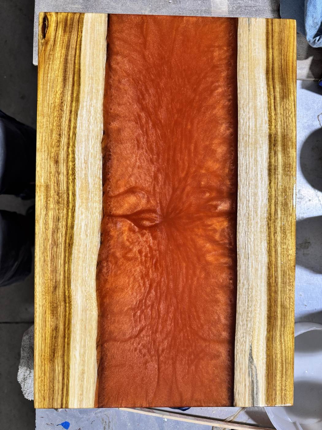 Wood and red resin river board